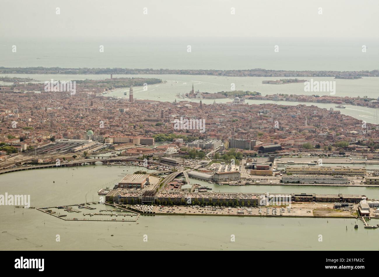View from a plane looking across the Port of Venice with the Tronchetto island at the bottom and Lido towards the top. Stock Photo