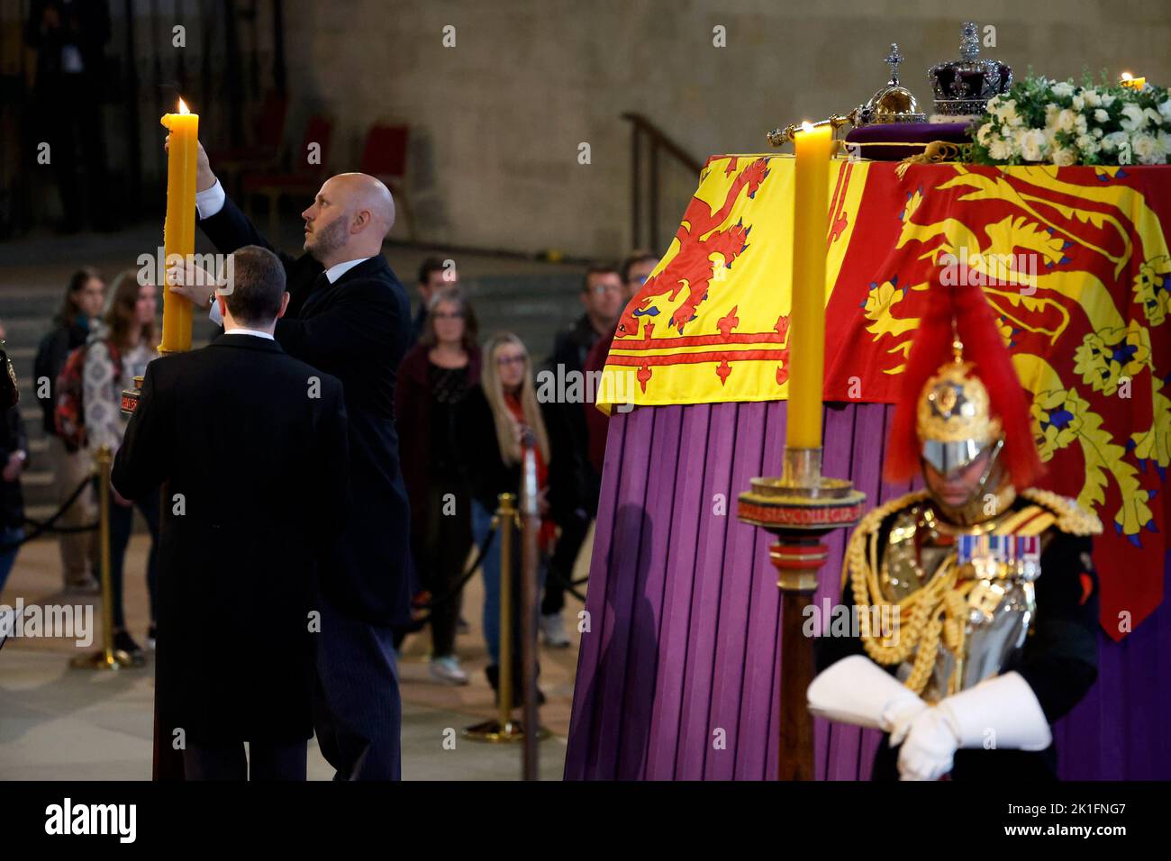 Wax is removed where Queen Elizabeth II's flag-draped coffin is lying in state on the catafalque at Westminster Hall, London, ahead of her funeral on Monday. Picture date: Sunday September 18, 2022. Stock Photo