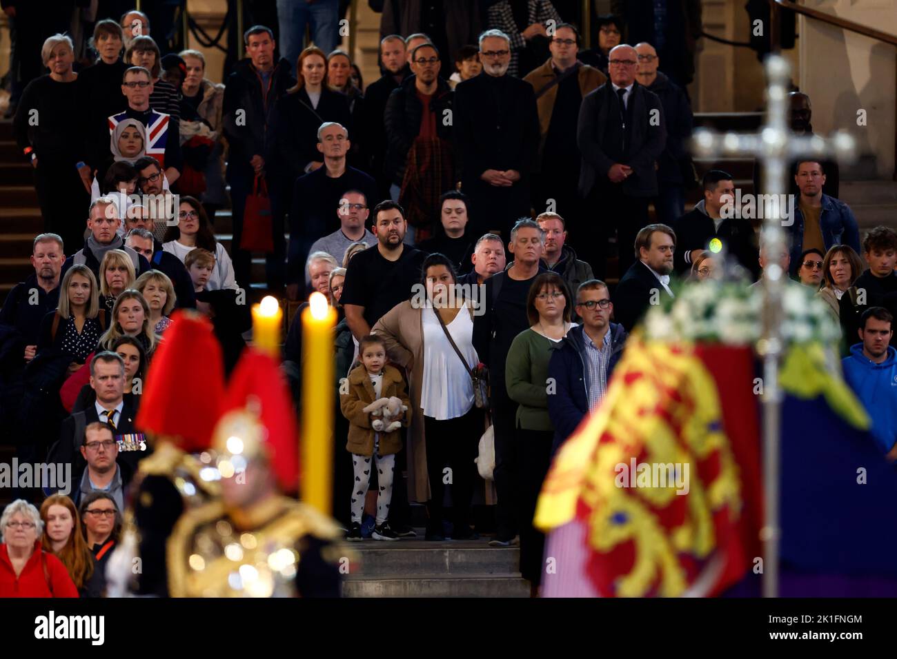 Members of the public view the coffin of Queen Elizabeth II, lying in state on the catafalque in Westminster Hall, at the Palace of Westminster, London, ahead of her funeral on Monday. Picture date: Sunday September 18, 2022. Stock Photo