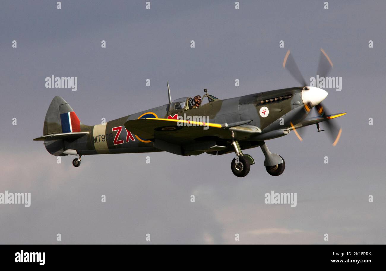 Supermarine Spitfire Mk.VIII, MV154 (G-BKMI) landing at dusk, after it's flying display at the IWM Duxford Battle of Britain Air show 10th September Stock Photo