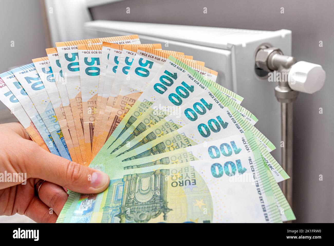 A stack of money on the background of the radiator. Stock Photo