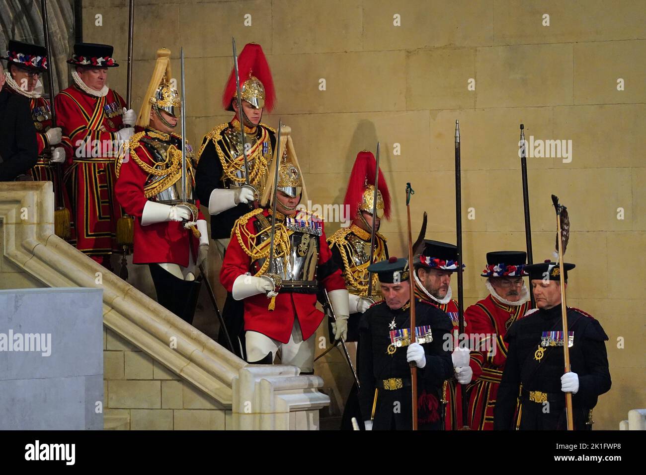 Royal guards change duties as the coffin of Queen Elizabeth II, lies in state on the catafalque in Westminster Hall, at the Palace of Westminster, London, ahead of her funeral on Monday. Picture date: Sunday September 18, 2022. Stock Photo