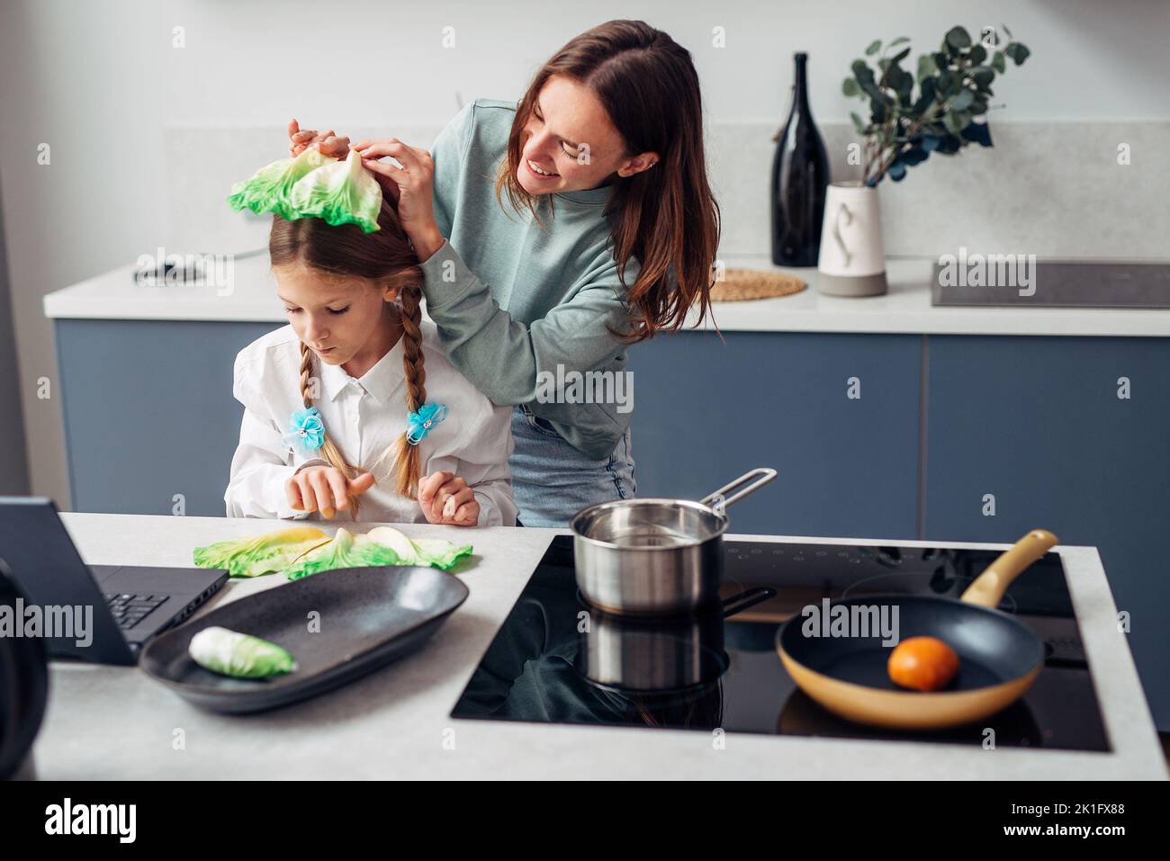 Mother and daughter in the kitchen cooking, having fun. Stock Photo