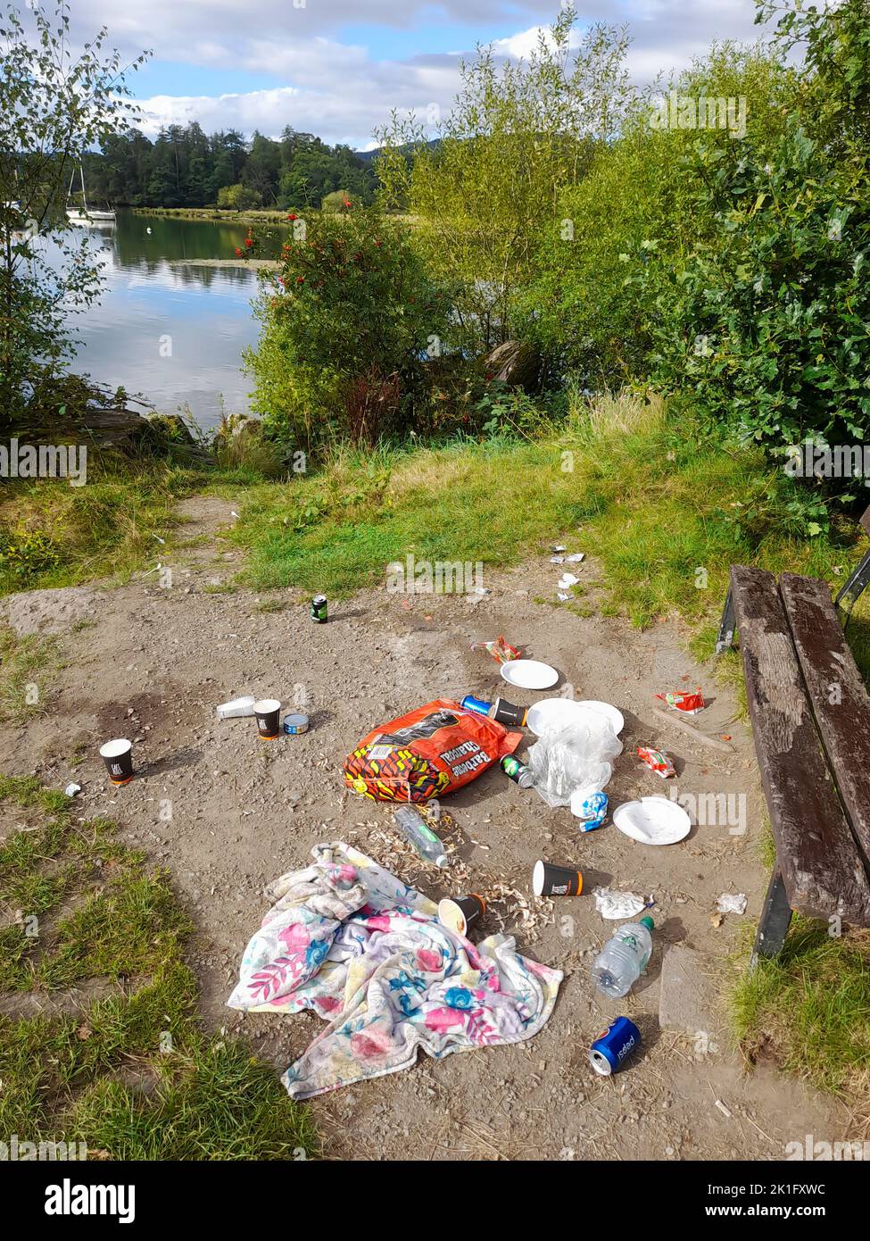 Trash left behind by an idiot family on the shores of Lake Windermere in Ambleside, Lake District, UK, following a barbeque. Stock Photo