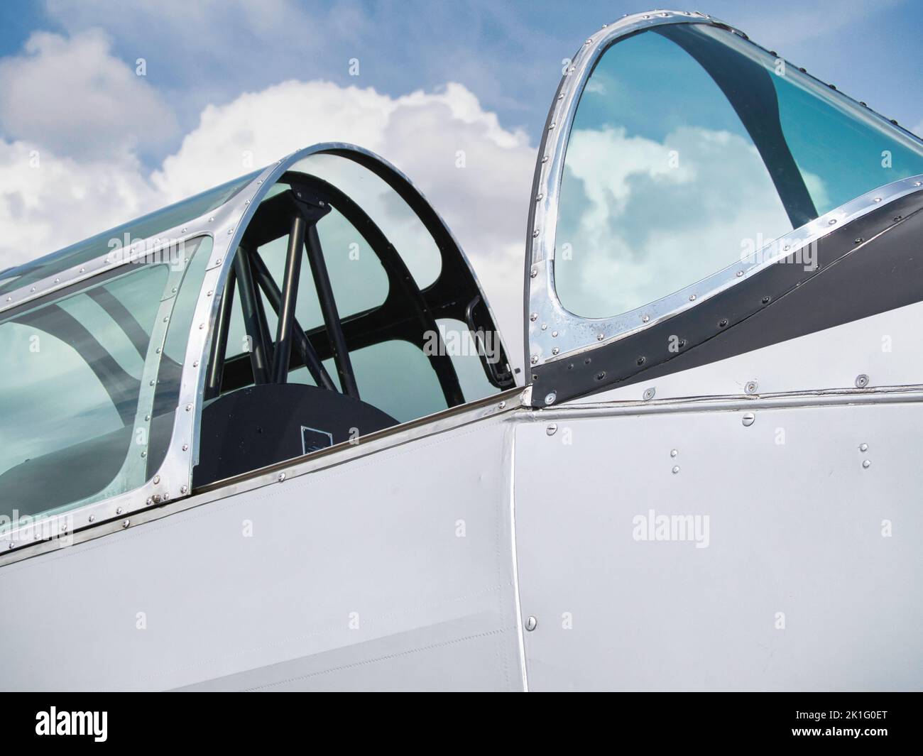 Open cockpit of an old airplane with sky background Stock Photo