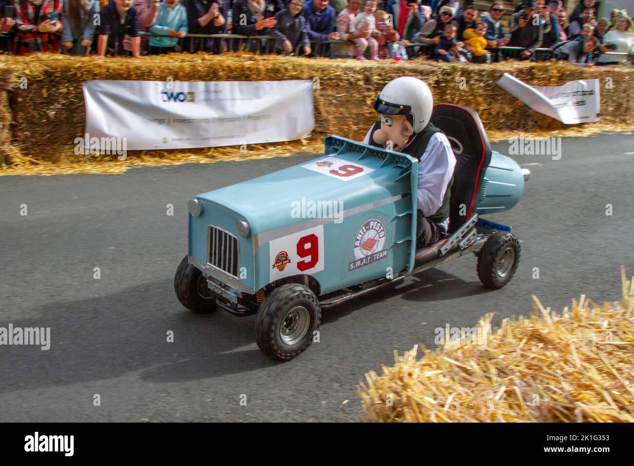 Longridge, Preston. UK News 18 September 2022; Soapbox Derby community charity event happening in the heart of the village. A day of “family fun, racing, wacky costumes and carts, thrills and spills” attracted thousands of visitors to the town's main street. Motorless, hand-made, wooden vehicles raced down Berry Lane as the village's main high street was converted into an unusual race track for the day. The event has been organised to raise vital funds for local charity Longridge Community Action. 'Ratty' entrant Dave driving Anti-Pesto Wheelie Bin. Credit ; MediaWorldImages/Alamy LiveNews Stock Photo