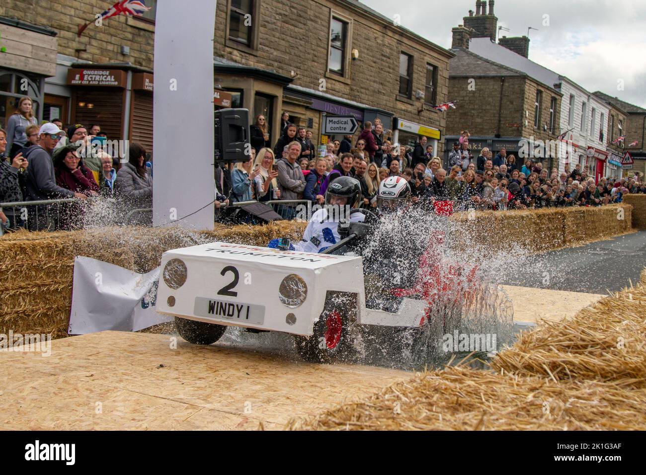 Longridge, Preston. UK News 18 September 2022; Soapbox Derby community charity event happening in the heart of the village of Longridge, Lancashire. A day of “family fun, racing, wacky costumes and carts, thrills and spills” attracted thousands of visitors to the town's main street. Motorless, hand-made, wooden vehicles raced down Berry Lane as the village's main high street was converted into an unusual race track for the day. The event has been organised to raise vital funds for local charity Longridge Community Action. Credit ; MediaWorldImages/Alamy LiveNews Stock Photo