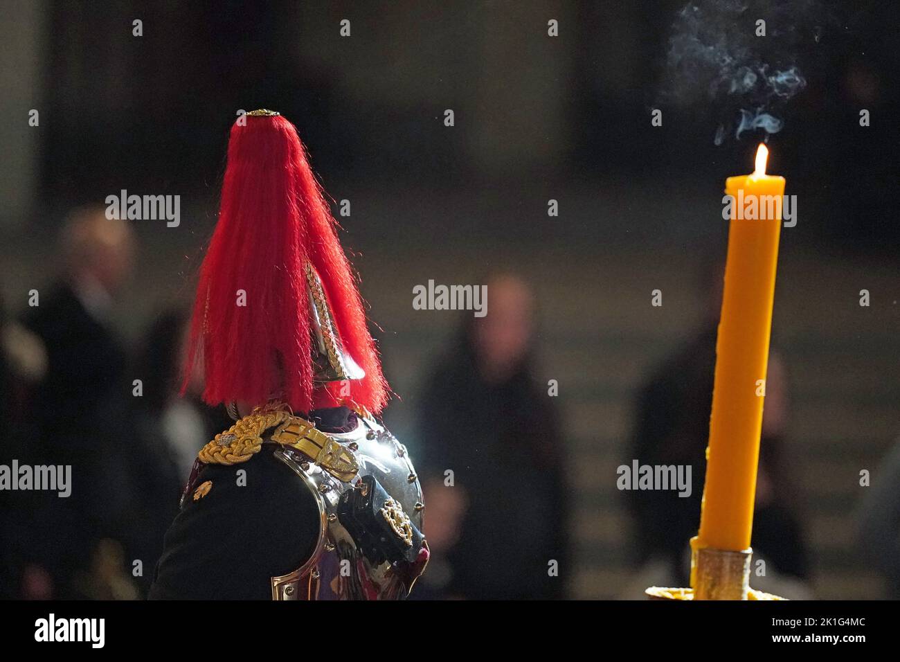 A Royal guard at the coffin of Queen Elizabeth II, as it lies in state on the catafalque in Westminster Hall, at the Palace of Westminster, London, ahead of her funeral on Monday. Picture date: Sunday September 18, 2022. Stock Photo