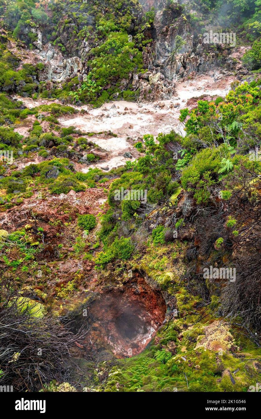 Carbon dioxide and sulfur gases vent from volcanic fumaroles in the Furnas do Enxofre nature park in Terceira Island, Azores, Portugal. The Azores are home to 26 active volcanoes, 8 of which are underwater. Stock Photo