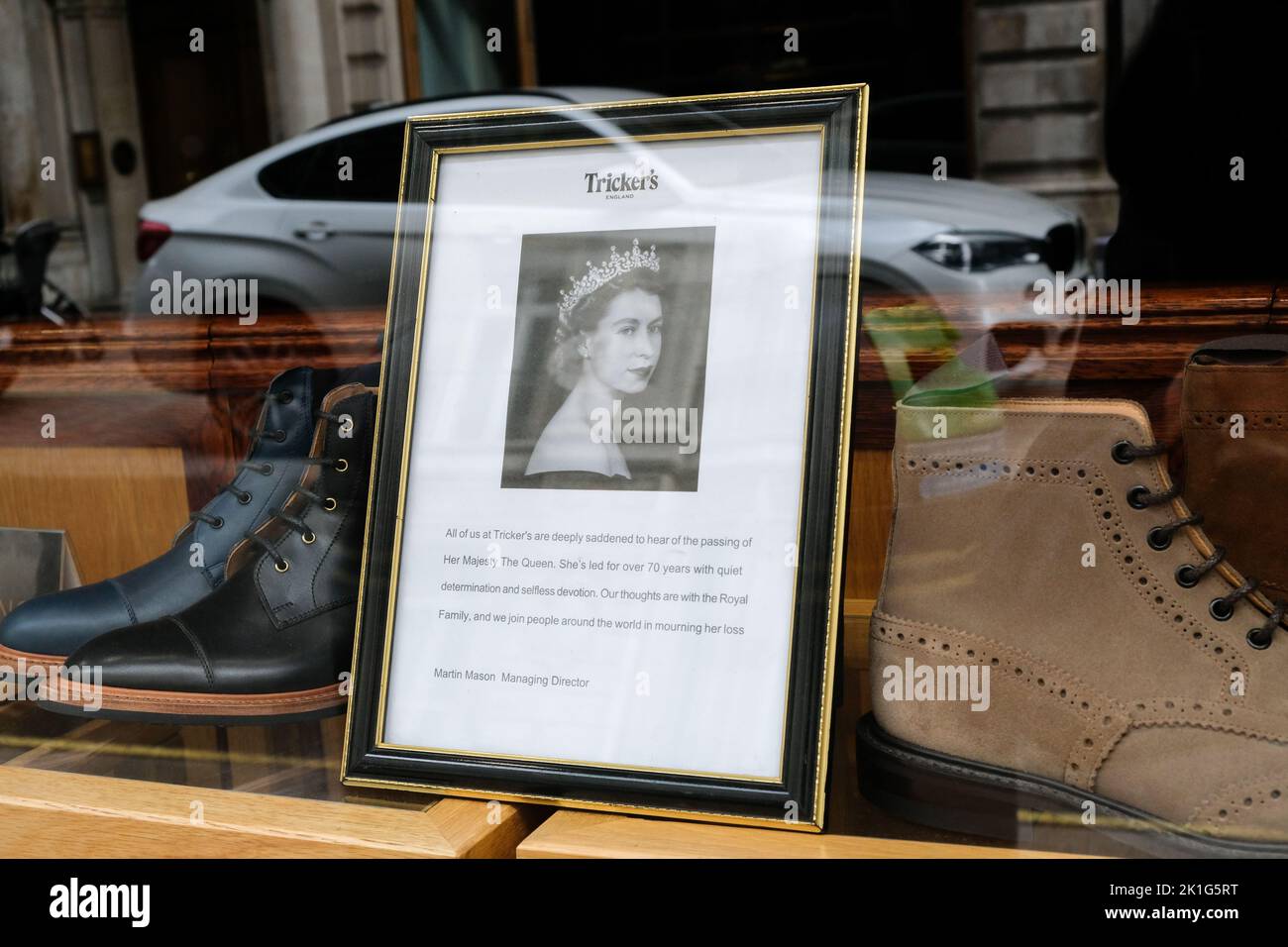 Jermyn Street, London, UK. 18th Sept 2022. Mourning the death of Queen Elizabeth II aged 96. Shop windows near Piccadilly display pictures and dedications to Queen Elizabeth. Tricker's, Jermyn Street. Credit: Matthew Chattle/Alamy Live News Stock Photo