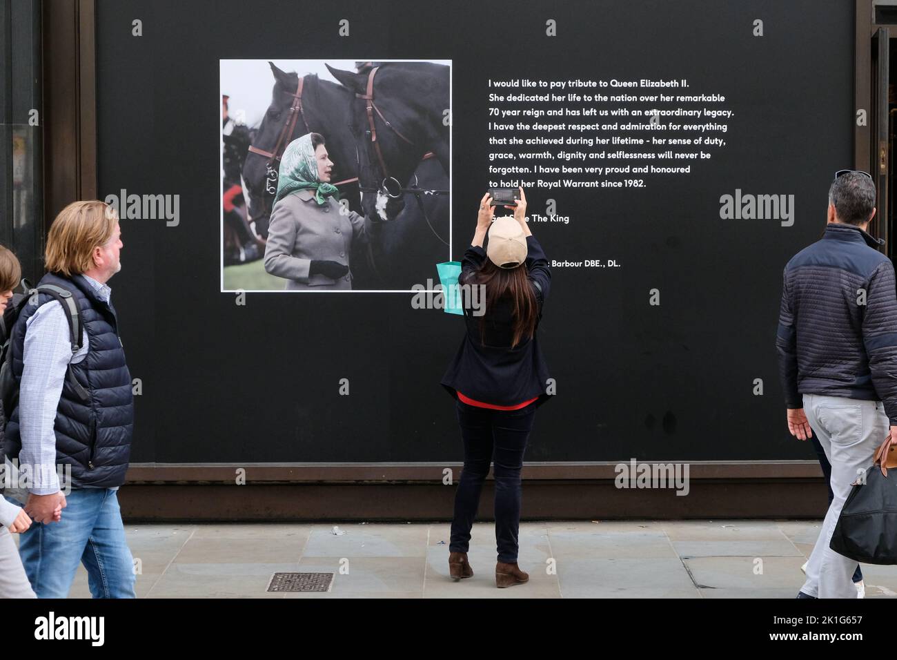 Piccadilly, London, UK. 18th Sept 2022. Mourning the death of Queen Elizabeth II aged 96. Shop windows near Piccadilly display pictures and dedications to Queen Elizabeth. Barbour. Credit: Matthew Chattle/Alamy Live News Stock Photo