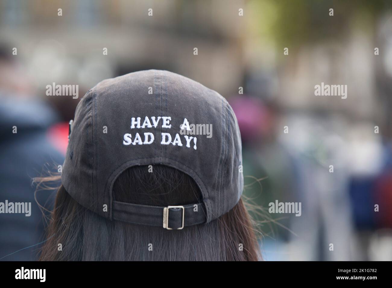 London, UK, 18 September 2022: Crowds are filling the streets of Whitehall to pay their respects to the late monarch Queen Elizabeth II, whose funeral takes place tomorrow. One woman wears a hat with the instruction 'Have a sad day!' which many people will tomorrow. Anna Watson/Alamy Live News Stock Photo