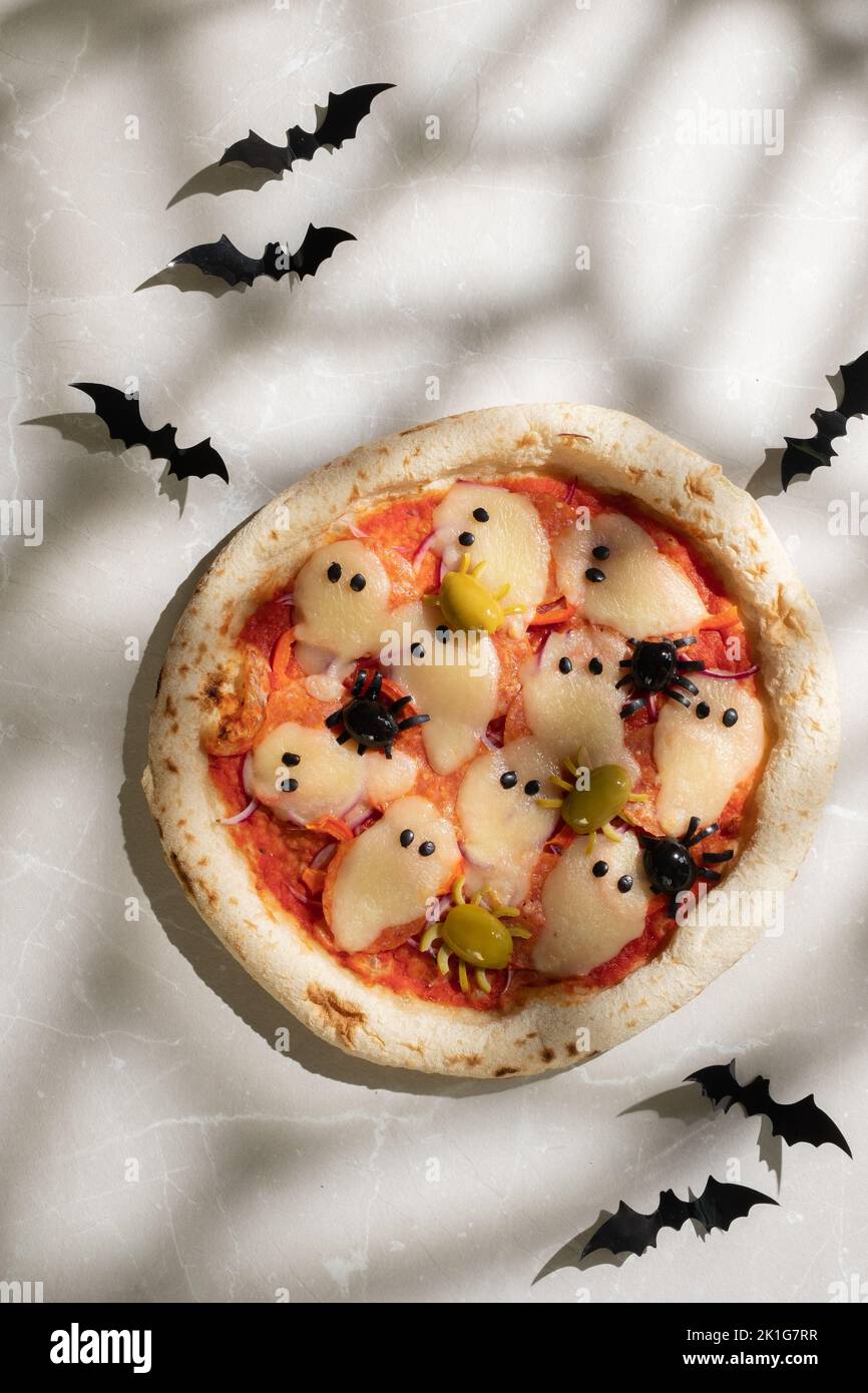 Ideas for Halloween. Pizza with olives spiders. Stock Photo