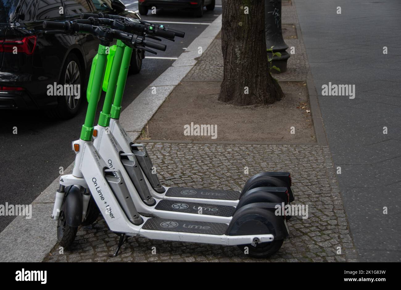 Berlin, Germany 28 June 2022, Three Lime electric scooters on a