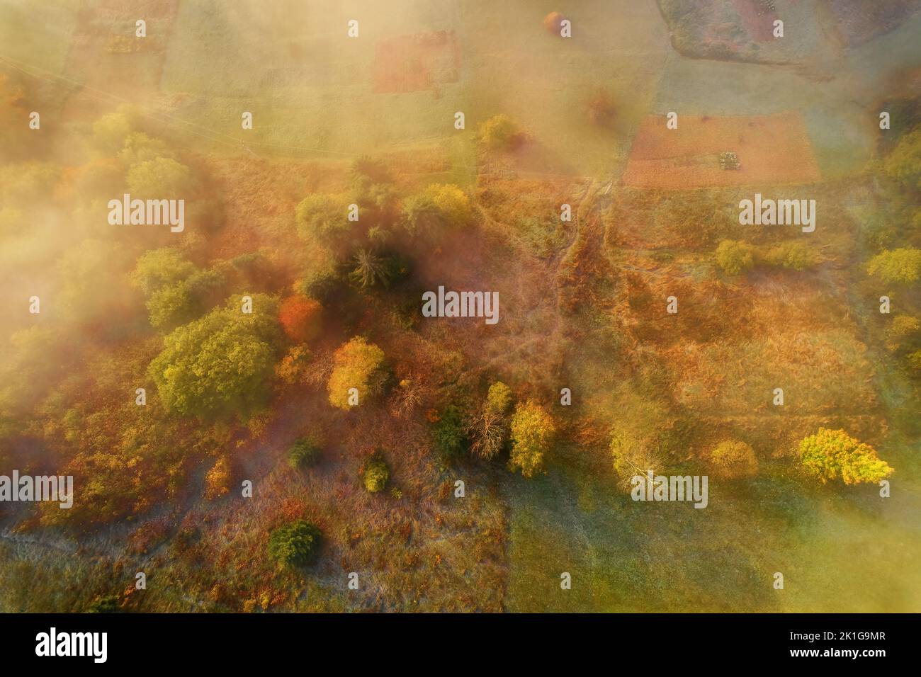 Mountains in clouds at sunrise in summer. Aerial view of mountain peak ...