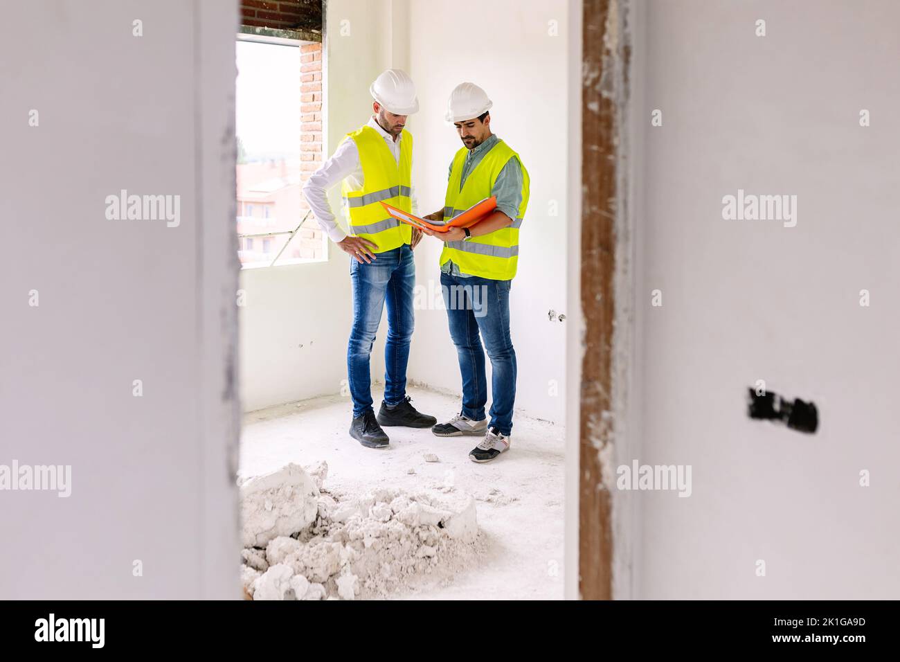 Two young architects male working together at construction site Stock Photo