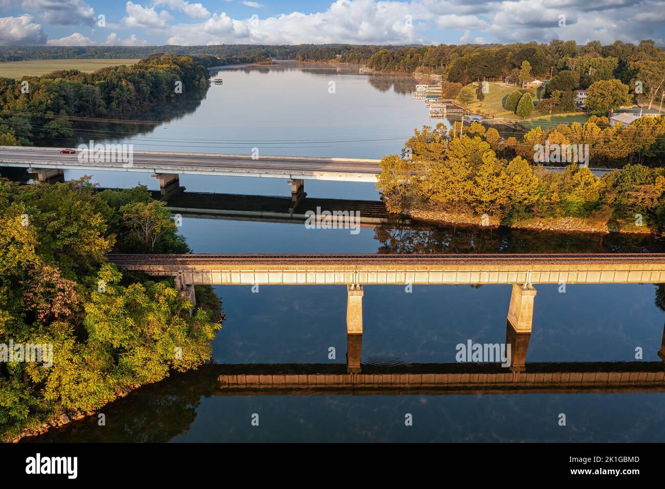 Train trestle and traffic bridge crossing the Elk River with lake homes