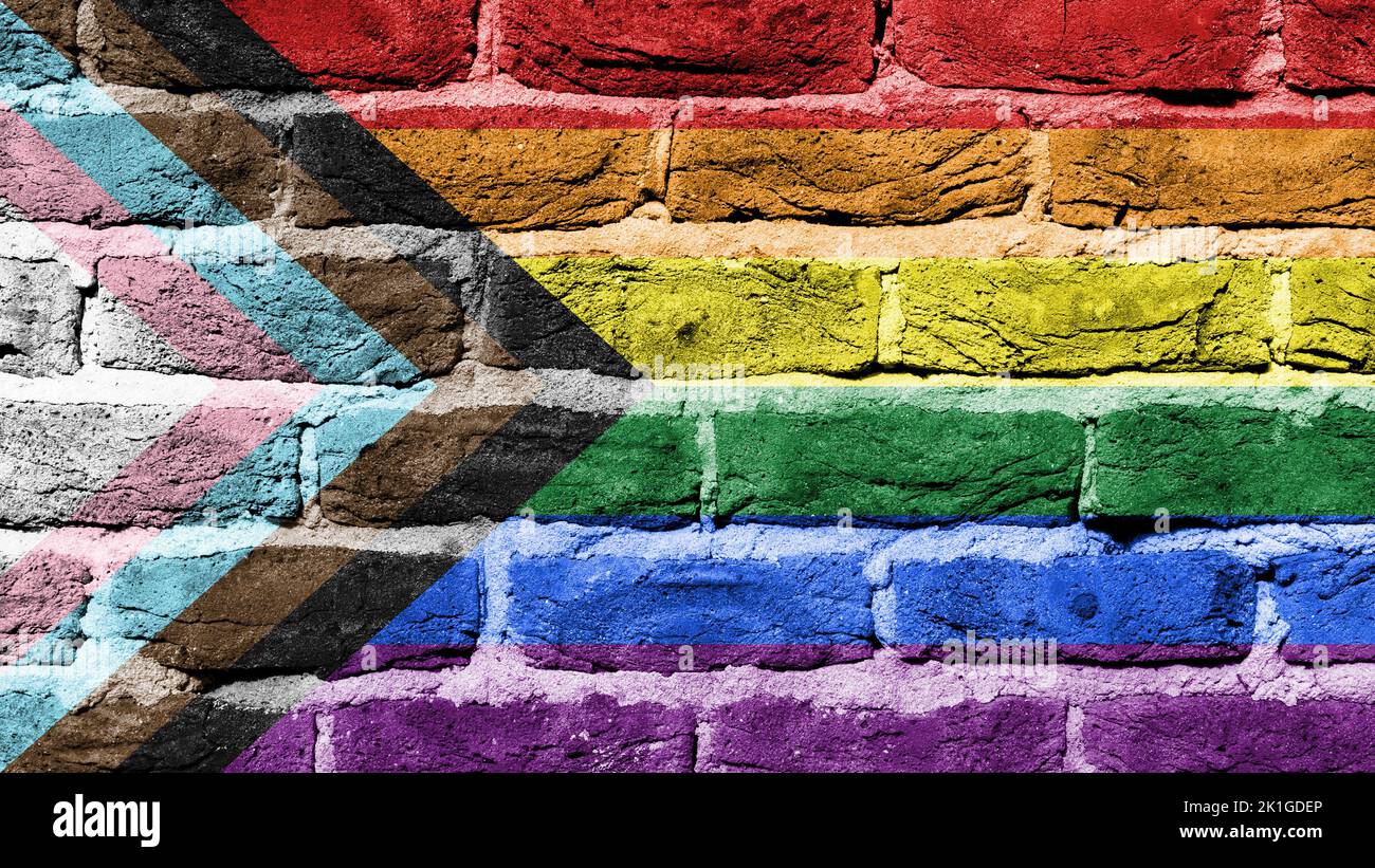 Progress LGBTQ rainbow on a brick wall, full frame Stock Photo