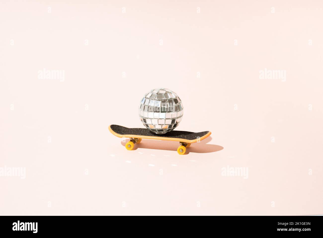 Disco ball on skateboard. Mininimal concept. Stock Photo