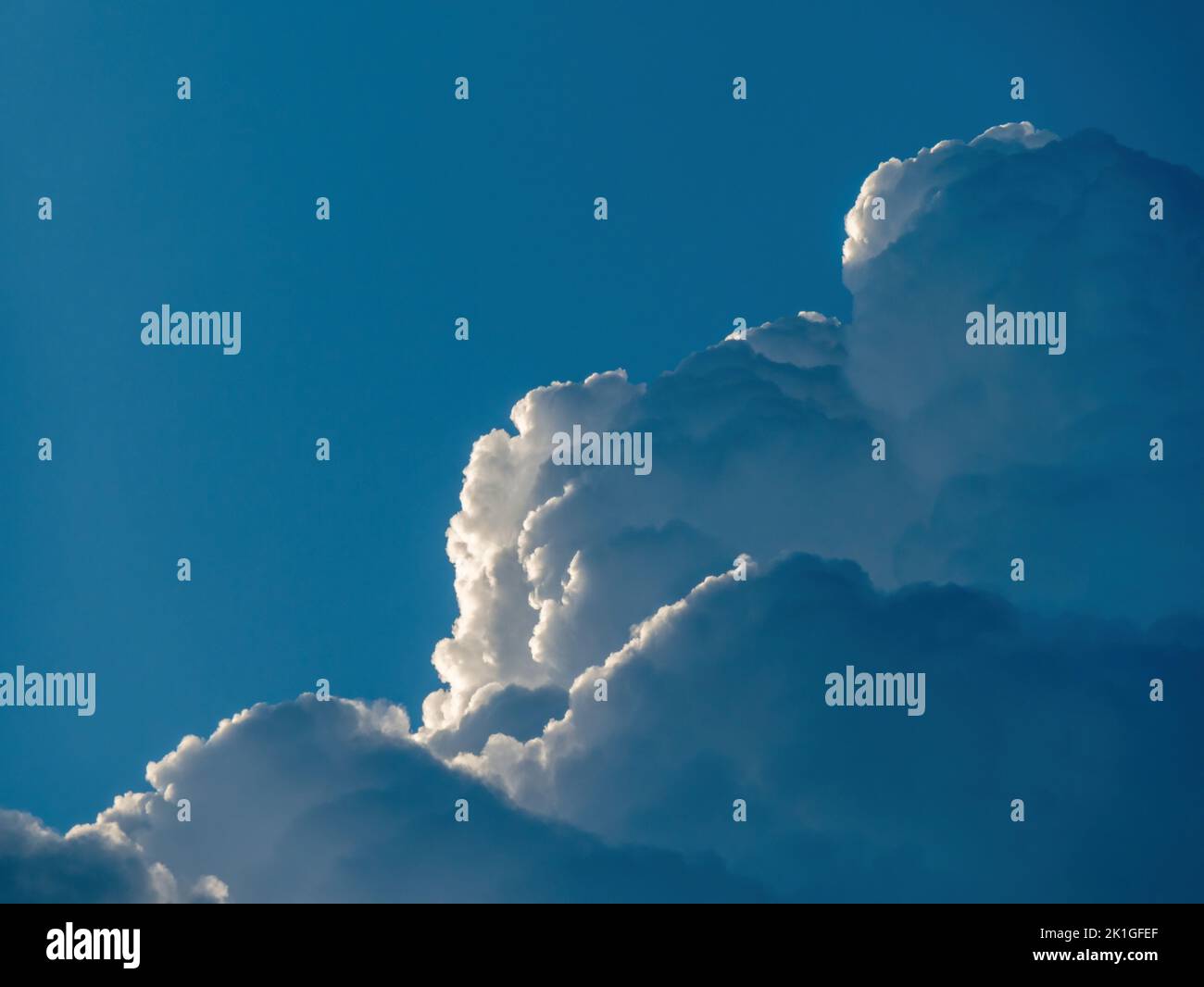 Building Cumulonimbus clouds against blue sky Stock Photo