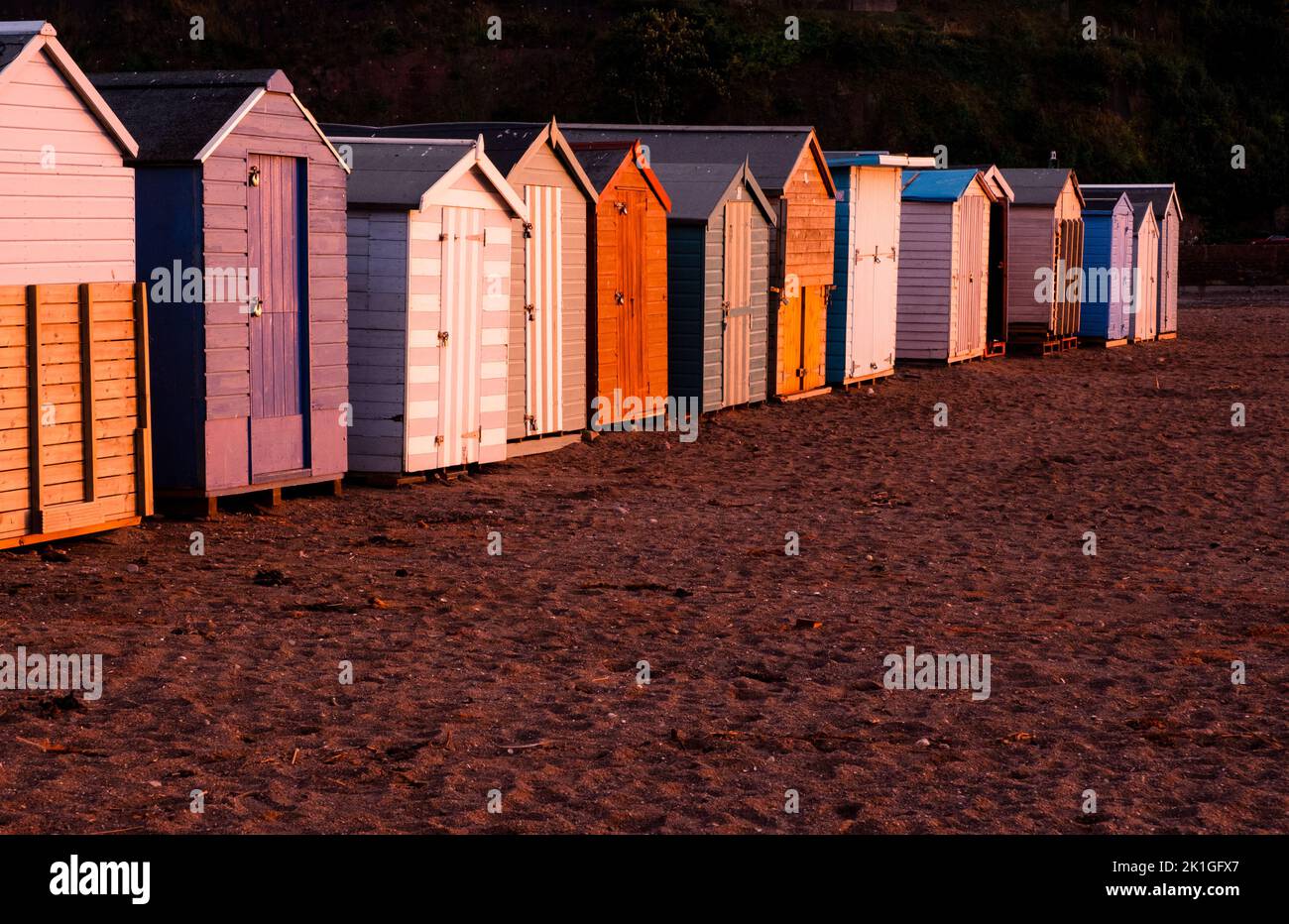 Beach huts at sunset on Teignmouth's 'back beach' Stock Photo - Alamy