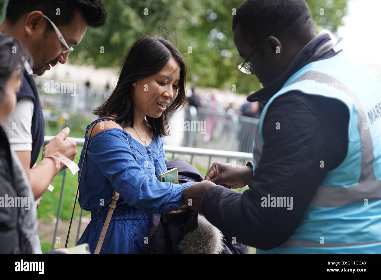 Marshalls putting on wristbands to members of the public near Tower