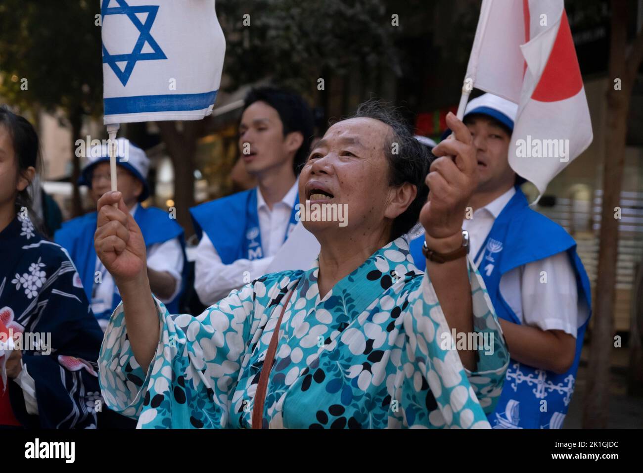 Members of the Japanese Makuya movement wave the national flags of Israel and Japan and sing iconic Jewish songs in Zion Square on September 18, 2022 in downtown Jerusalem, Israel. The Makuya movement is a religious movement which was founded in 1948 in Japan, Its members are passionate supporters of Israel and consider the establishment of the Jewish state and the unification of Jerusalem 19 years later to be the fulfillment of biblical prophecies. Stock Photo
