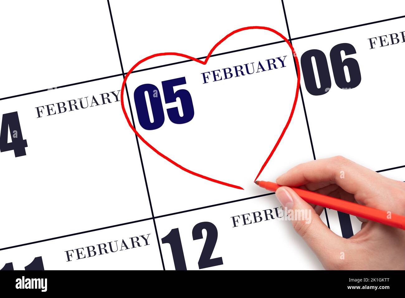 5th day of February. A woman's hand drawing a red heart shape on the ...