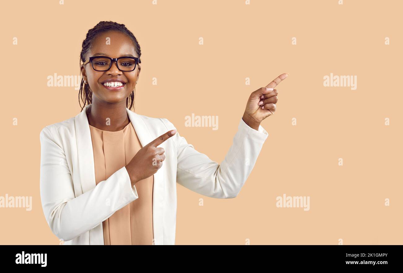 Smiling black woman point at copy space Stock Photo - Alamy