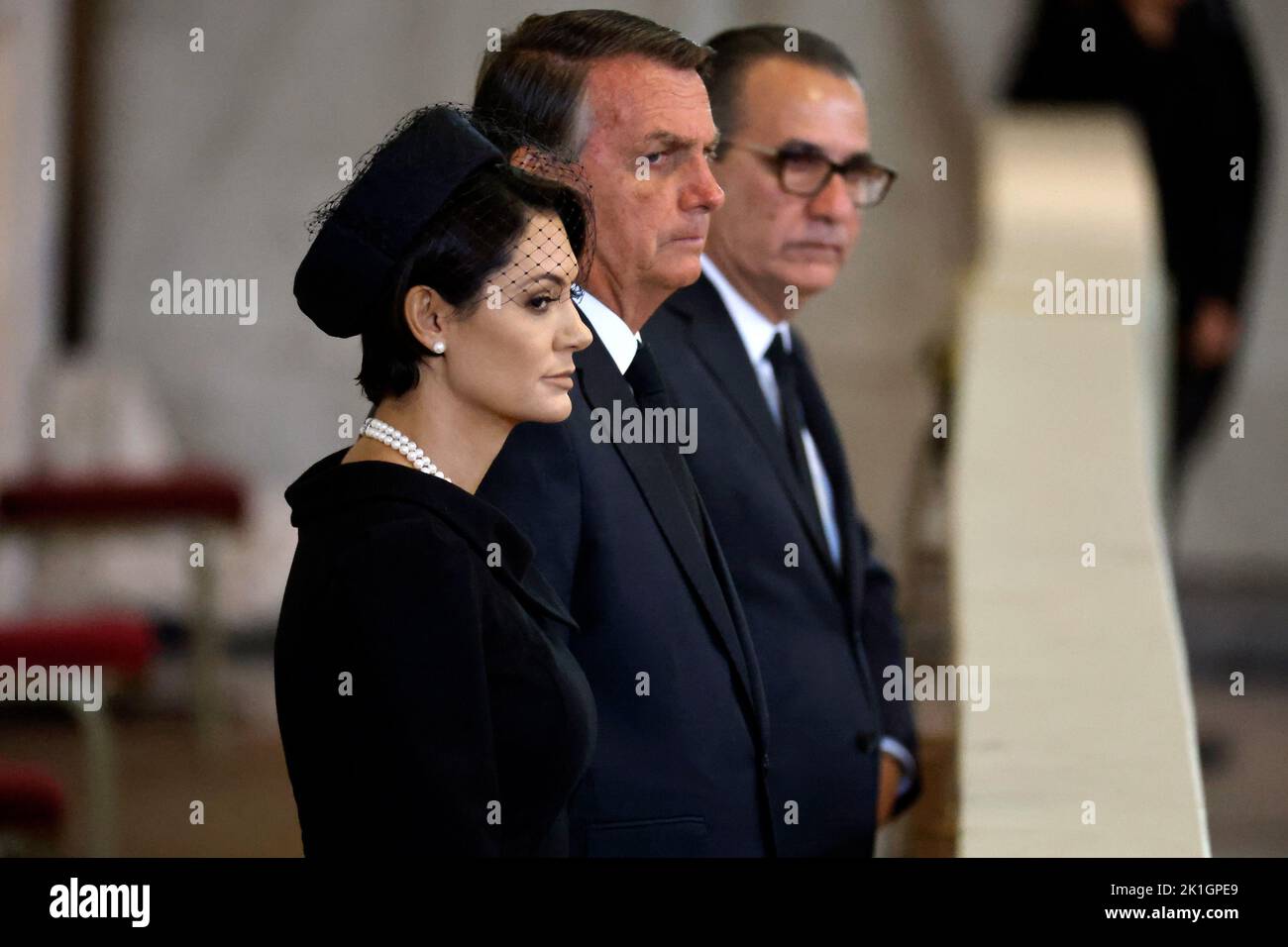 President Jair Bolsonaro of Brazil and his wife Michelle Bolsonaro pay their respects as they file past the coffin of Queen Elizabeth II, draped in the Royal Standard with the Imperial State Crown and the Sovereign's orb and sceptre, lying in state on the catafalque in Westminster Hall, at the Palace of Westminster ahead of her funeral on Monday. Picture date: Sunday September 18, 2022. Stock Photo