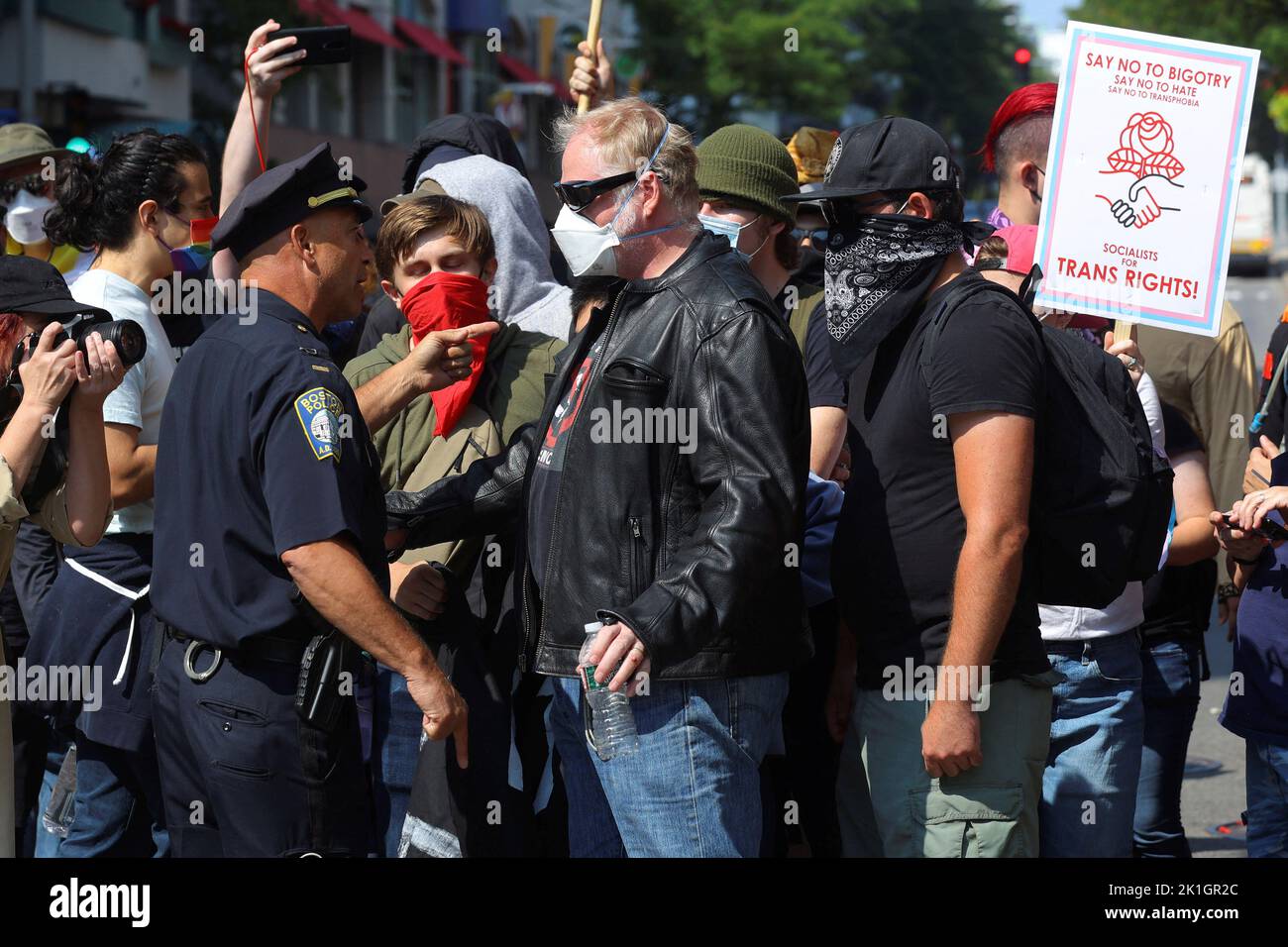 A police officer tries to contain counter-protestors gathered to demonstrate against an appearance by 'Billboard Chris', who opposes medical treatments for transgender youth, outside Children's Hospital in Boston, Massachusetts, U.S., September 18, 2022.     REUTERS/Brian Snyder Stock Photo