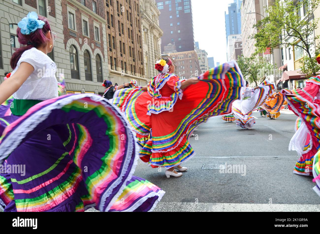Participants performing traditional folklore dance along Madison Avenue