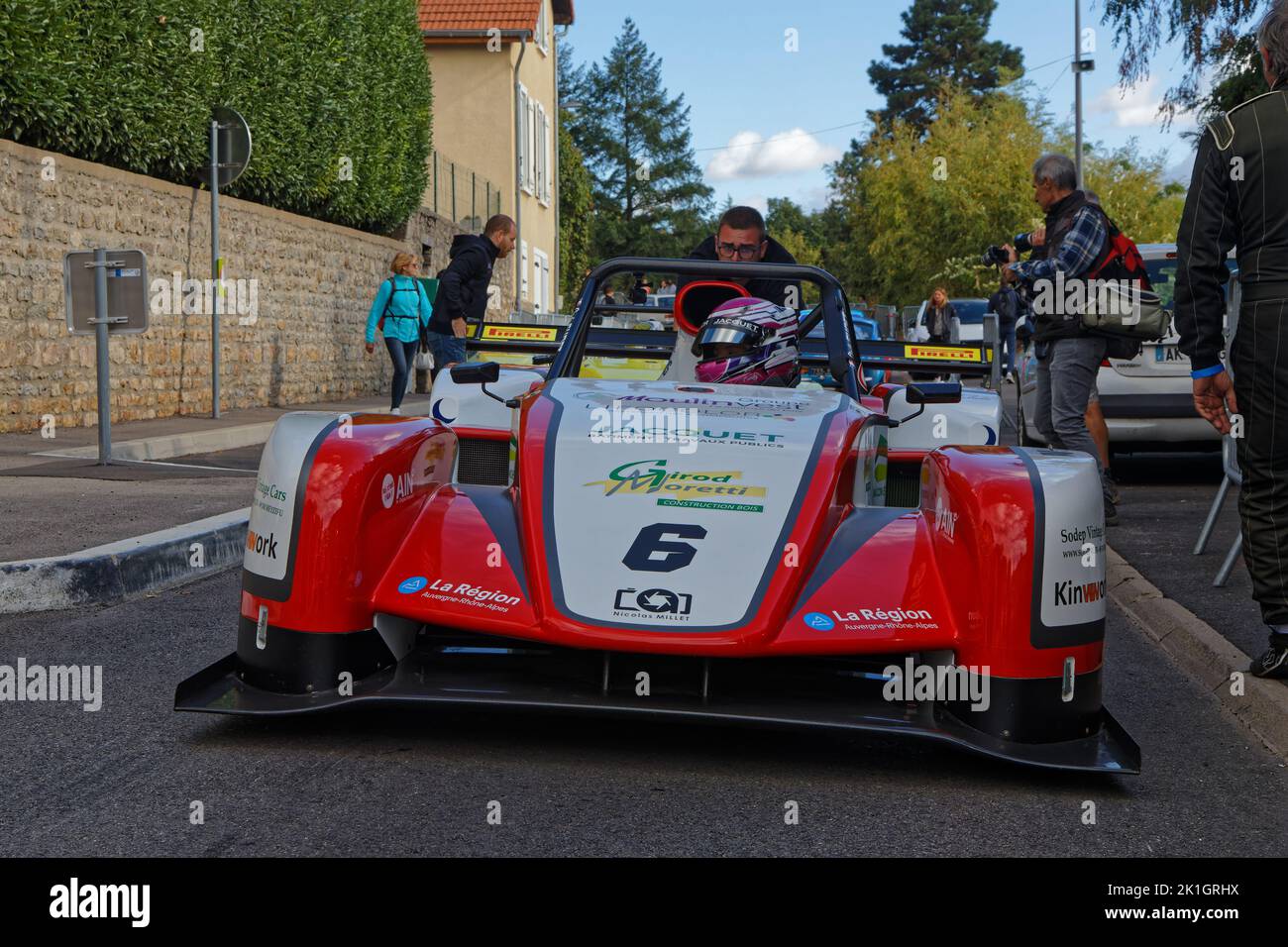 LIMONEST, FRANCE, September 17, 2022 : French woman driver Cindy Gudet's car is pushed in the streets of the village for the annual uphill car race. Stock Photo