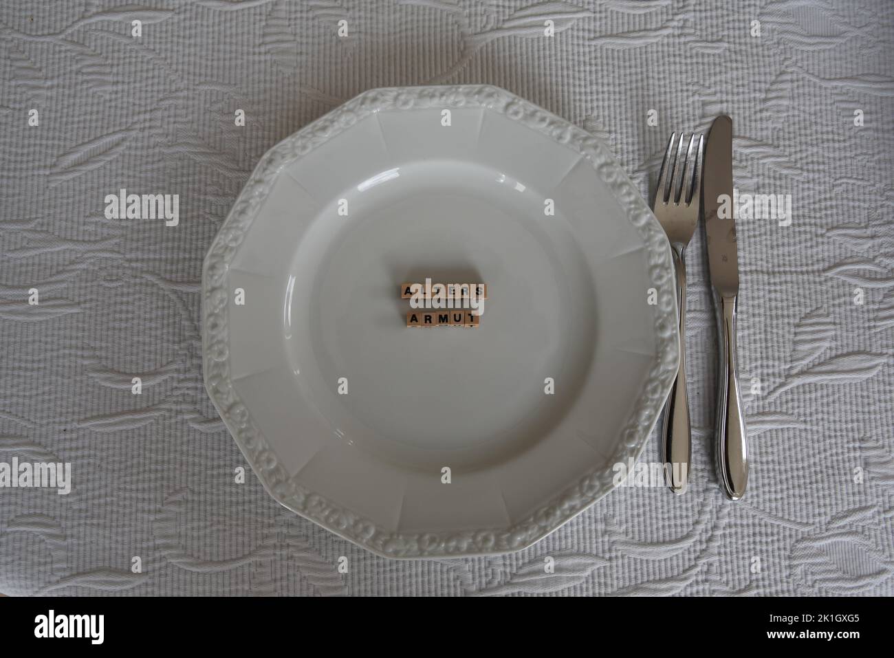 the german word for poverty with wodden bricks on a plate Stock Photo