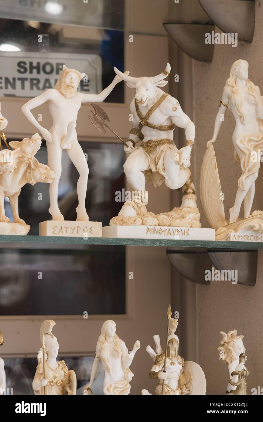 Classical Greek mythology figurines, including Priapus with an erection, on display as souvenirs and trinkets for tourists in the village of Pyrgos Ka Stock Photo