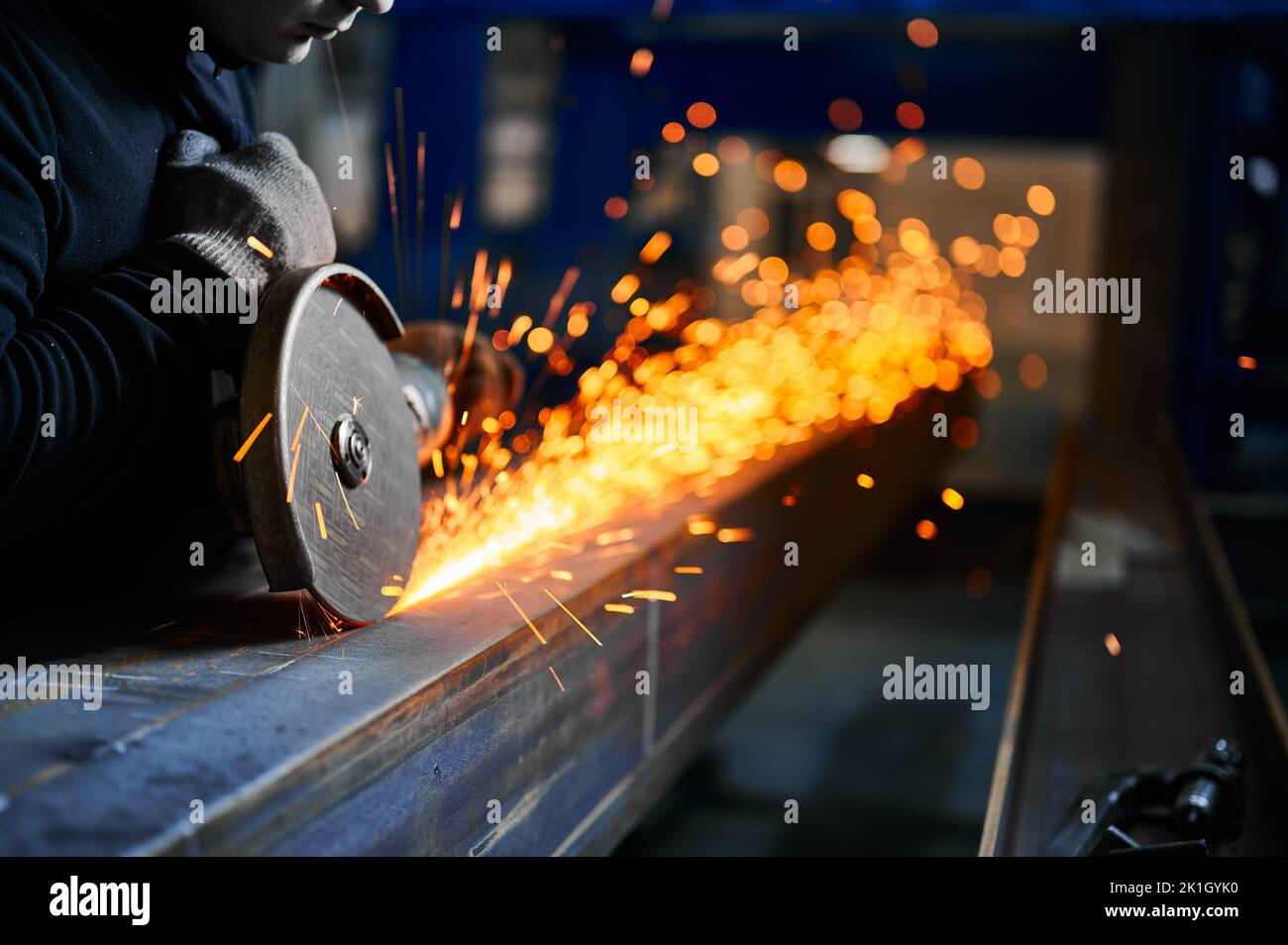Cutting of metal beam with abrasive tool at metalwork plant Stock Photo