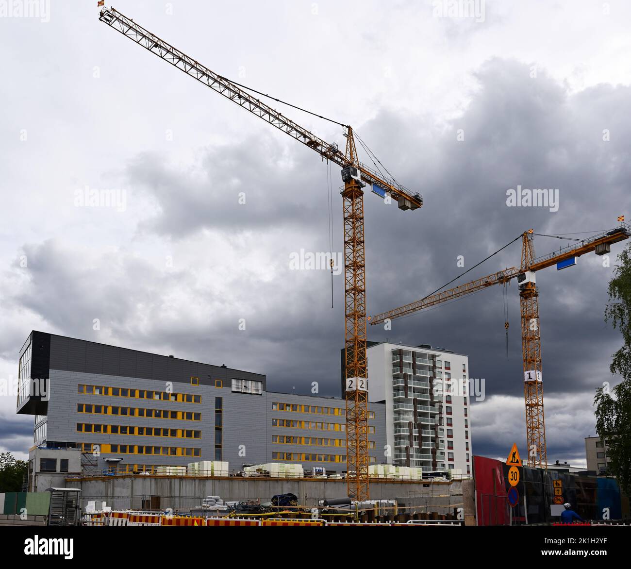 two cranes at the construction site of residential buildings Stock Photo