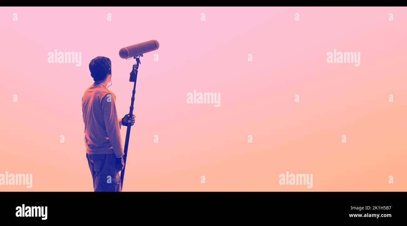 Boom Microphone for sound recording in film industry. Sound boom operator recording sound by