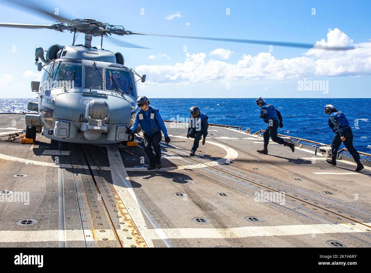 PHILIPPINE SEA (Sept. 16, 2022) Sailors prepare to chalk and chain an MH-60R Helicopter assigned to the “SABERHAWKS” of Helicopter Maritime Strike Squadron (HSM-77) during flight deck operations aboard Ticonderoga-class guided-missile cruiser USS Chancellorsville (CG 62) in the Philippine Sea on Sept. 16, 2022. Chancellorsville is forward-deployed to the U.S. 7th Fleet in support of security and stability in the Indo-Pacific and is assigned to Commander, Task Force 70, a combat-ready force that protects and defends the collective maritime interest of its allies and partners in the region. (U.S Stock Photo