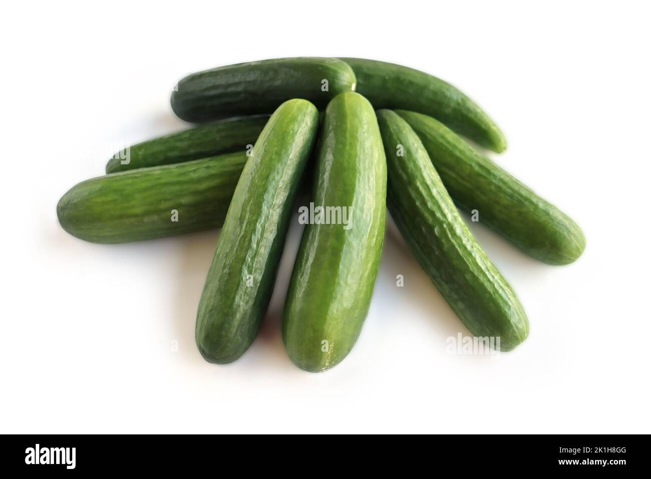 Isolated Heap of green Cucumbers, group of fresh cucumbers on the white background. Close-up, top view, macro, copy space Stock Photo