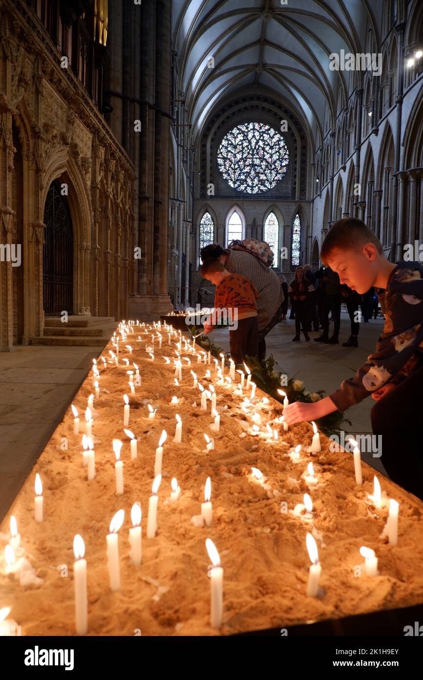 Visitors lighting candles as tributes to Queen Elizabeth II at Lincoln