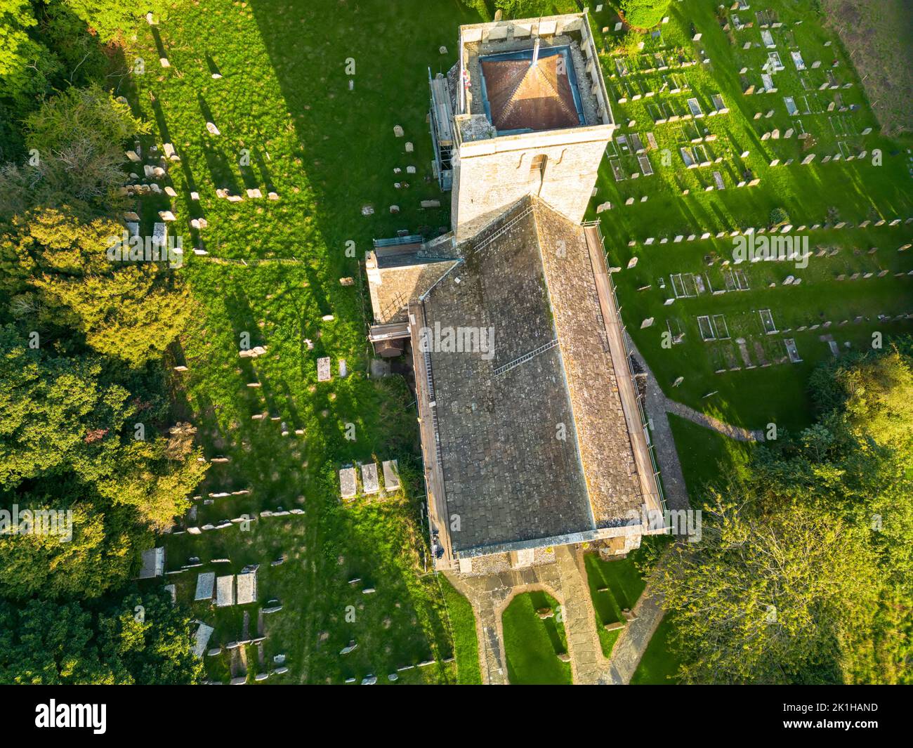 An aerial view of the church of St Mary the Virgin and the churchyard in evening sunlight, in the village of Shipley, West Sussex, England, UK Stock Photo