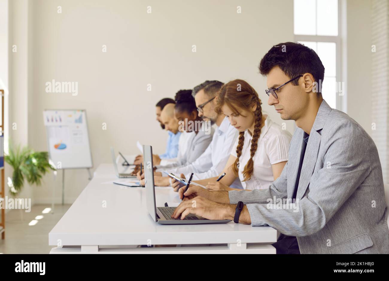 Group of business people or corporate employees working in modern office workplace Stock Photo