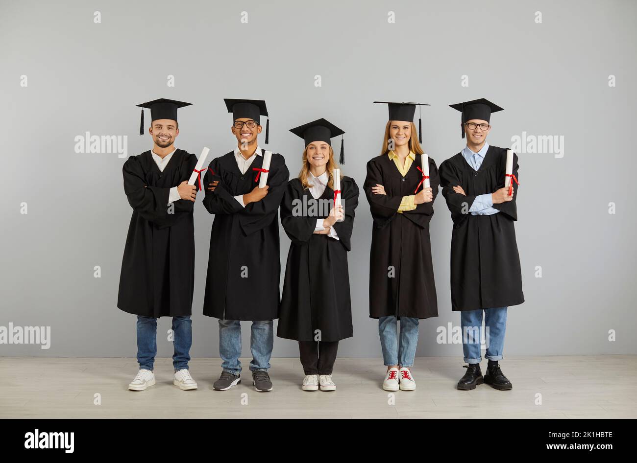 Portrait of diverse students graduates with diplomas Stock Photo