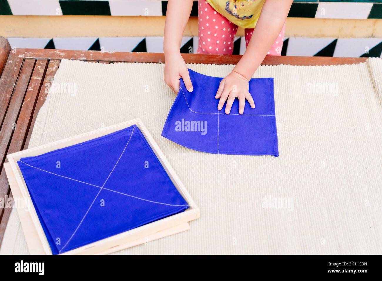 Folding napkins for children is a task to improve the fine motor skills