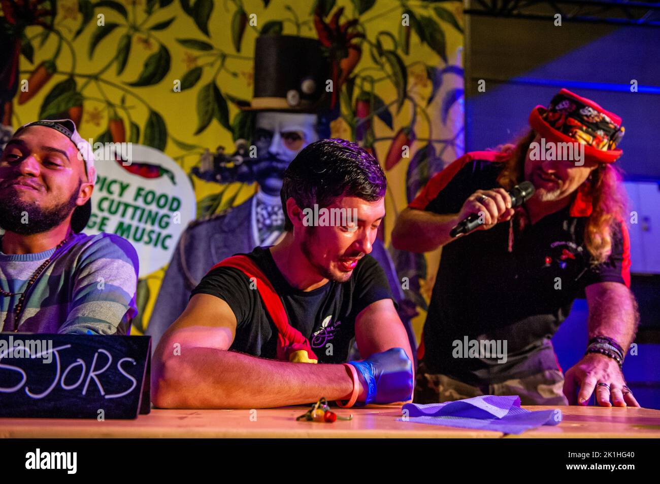 The host makes jokes with a participant during the Dutch Chili Festival