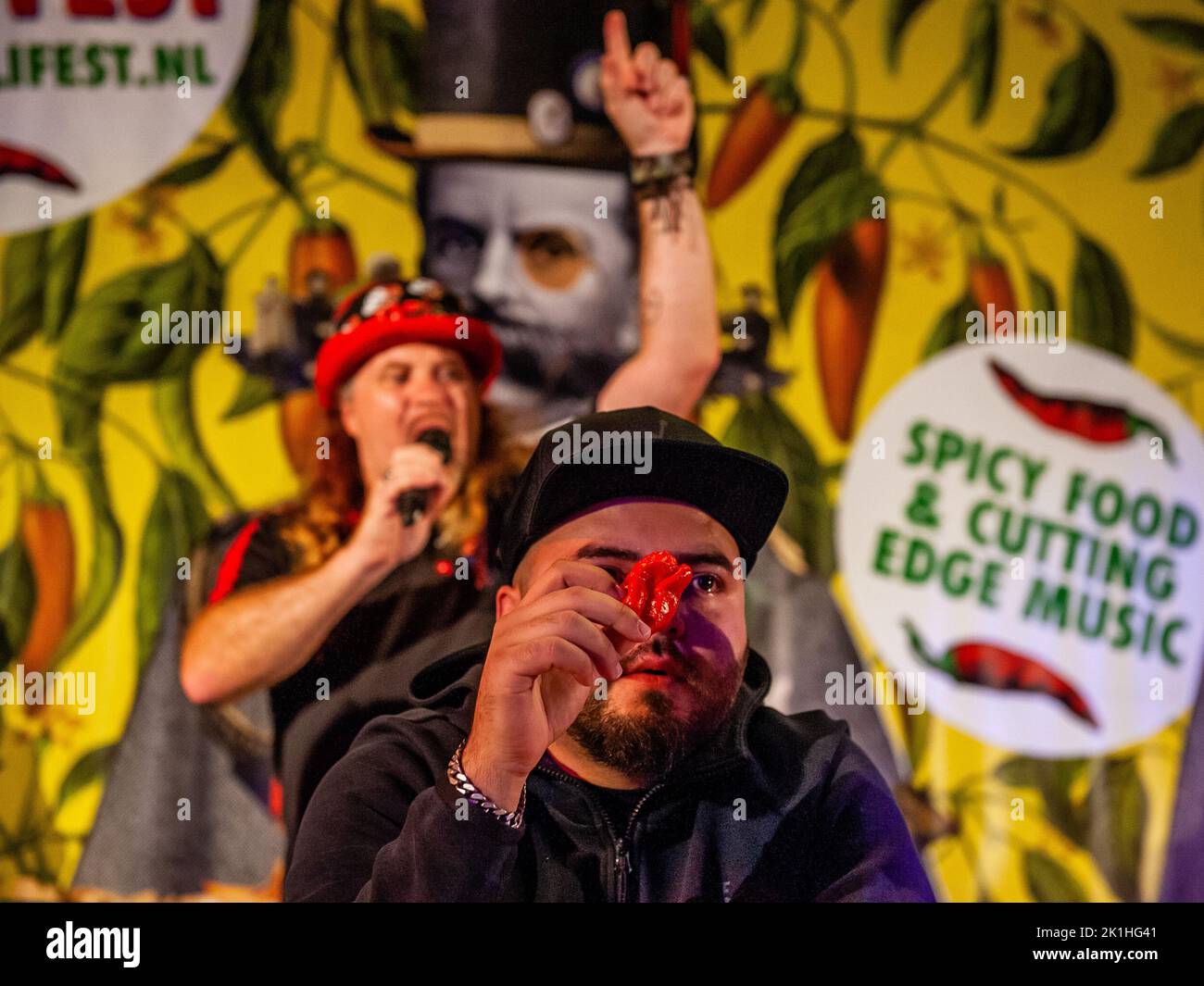 A participant shows the audience the pepper that he is about to eat