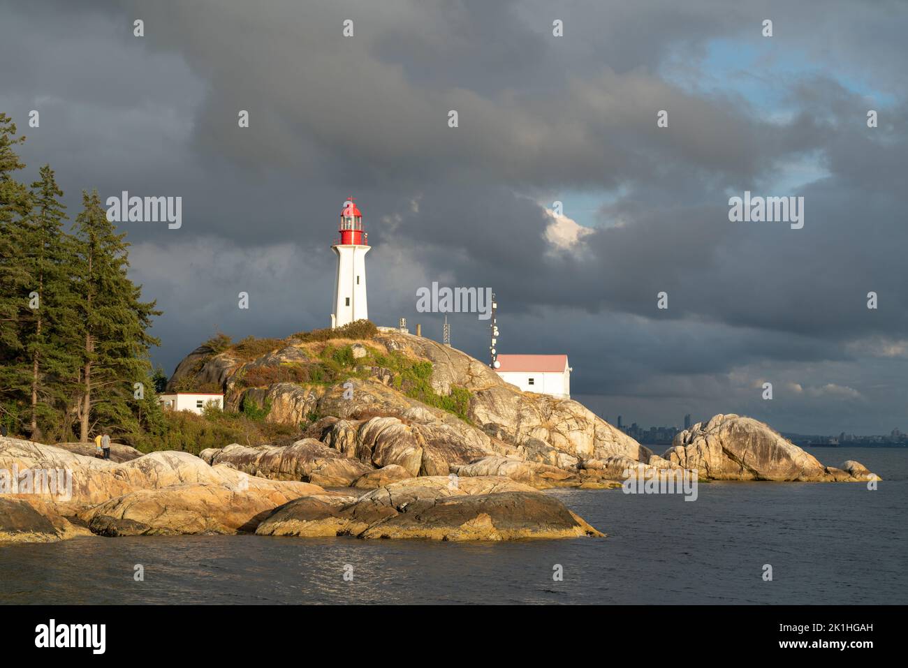 Sunlight hitting Atkinson Point Lighthouse with clouds in the backdrop ...