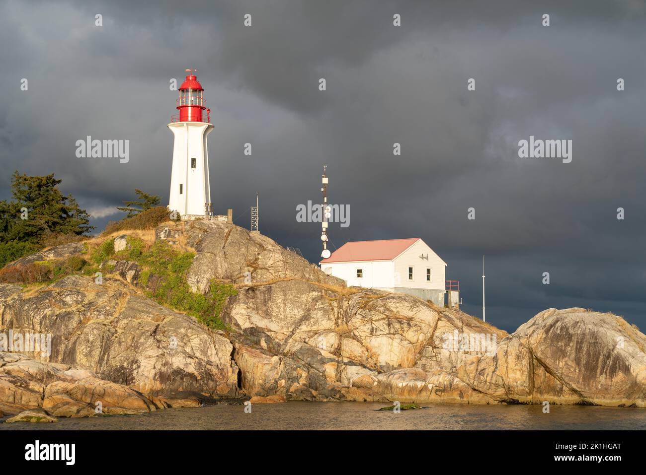 Sunlight hitting Atkinson Point Lighthouse with clouds in the backdrop ...