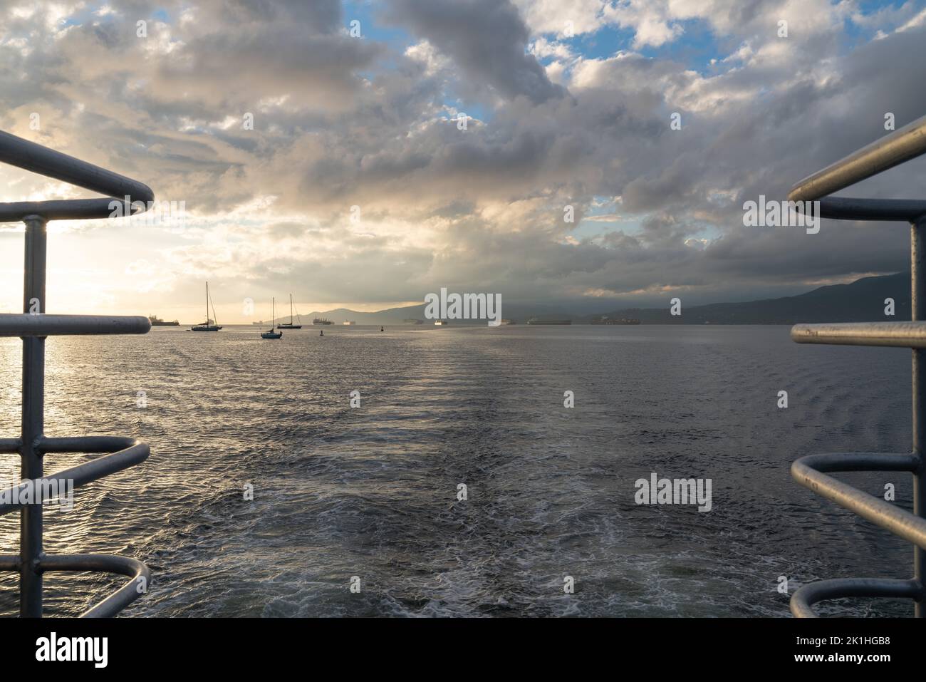 View from the taffrail of a whale watching ship, looking out over Burrard Inlet and all of the boats and container ships waiting offshore. Stock Photo